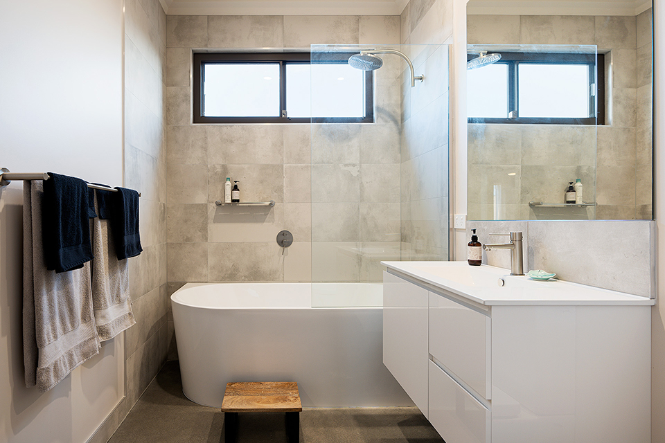 Bathroom with vanity and shower over bath